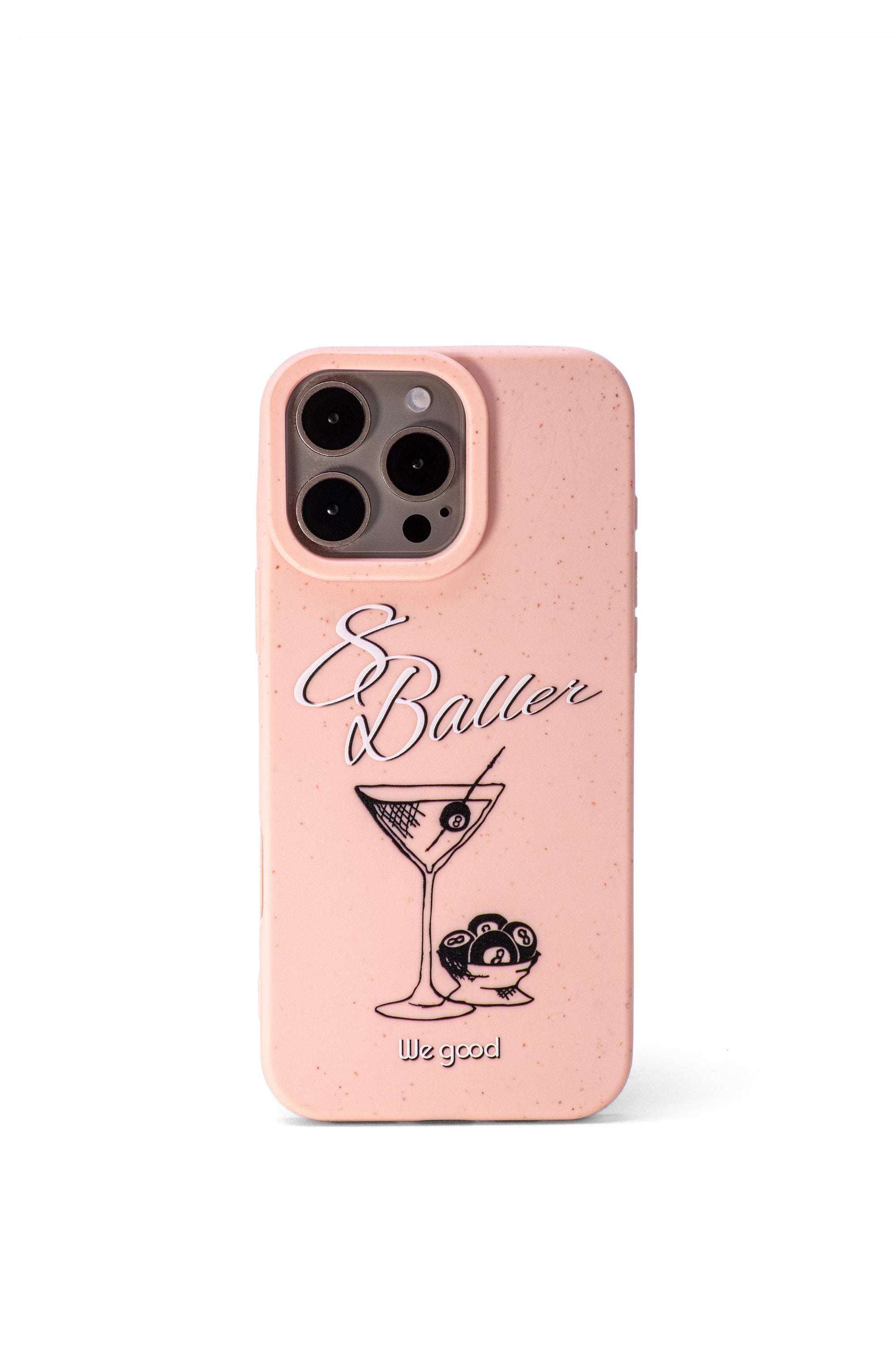 We Good Tpu iPhone case with wheat mix speckled in a flamingo pink color with '8 baller' white script text print and a black print martini glass with pool 8 balls. 
