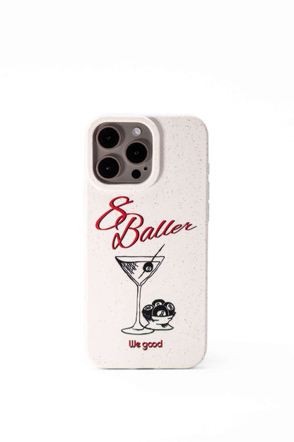 We Good Tpu iPhone case with wheat mix speckled in an off-white color with '8 baller' red script text print and a black print martini glass with pool 8 balls. 